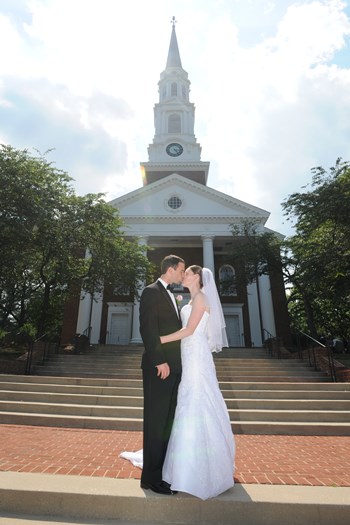 Couple kissing in front of chapel