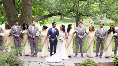 bridal party standing together under trees