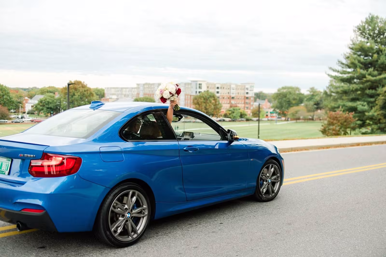 bride in a blue BMW